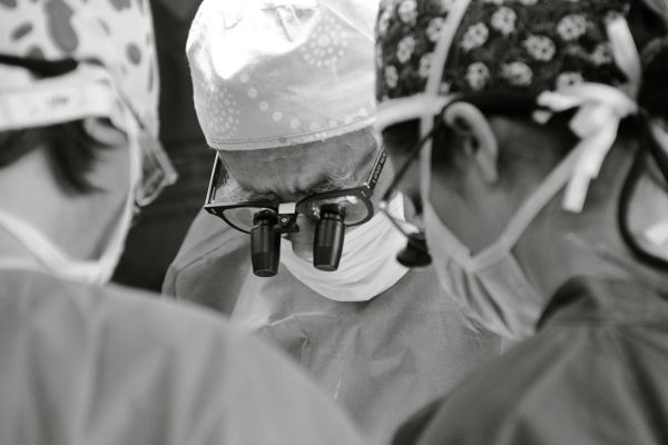Board-certified surgeon performing liposuction procedure